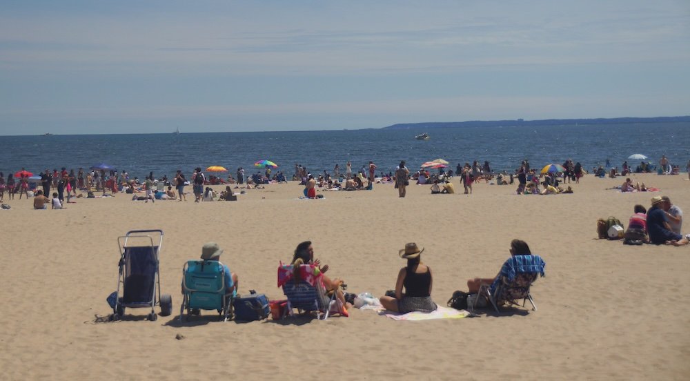 Coney Island people at the beach in New York City, USA 