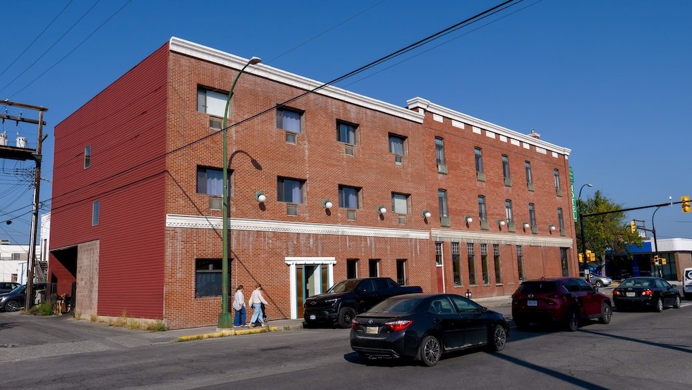 Cranbrook, BC downtown streetscape featuring historic brick buildings along a sunny intersection, highlighting the city’s early 20th-century architecture, walkable core, and small-town character that defines the heart of Cranbrook.
