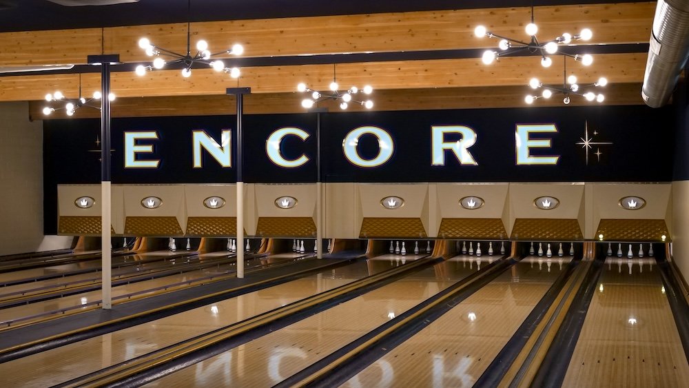 Cranbrook, BC at Encore Brewing shows polished bowling lanes beneath warm modern lighting, blending classic ten-pin bowling with a brewery atmosphere, making it a popular evening spot for food, drinks, and relaxed fun after a day of exploring town.
