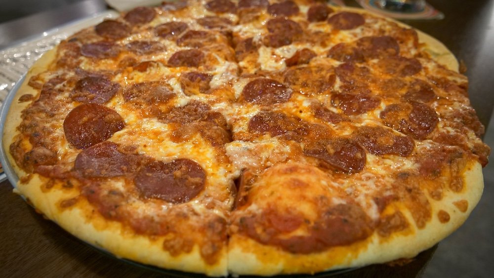Cranbrook, British Columbia pepperoni pizza at Encore Brewing, featuring a golden crust topped with melted cheese and spicy pepperoni, served during a relaxed bowling night and highlighting one of the most fun and casual places to eat in town.
