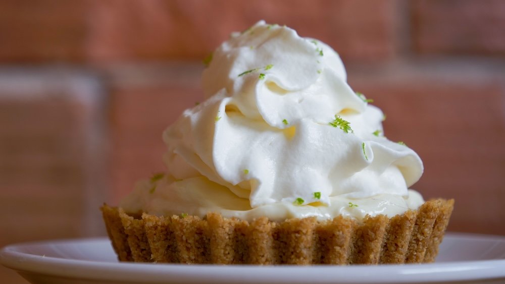 Cranbrook, British Columbia key lime pie dessert from Fire Hall Kitchen & Tap, featuring a thick graham cracker crust topped with silky lime filling and whipped cream, photographed inside one of the most popular restaurants in downtown Cranbrook.