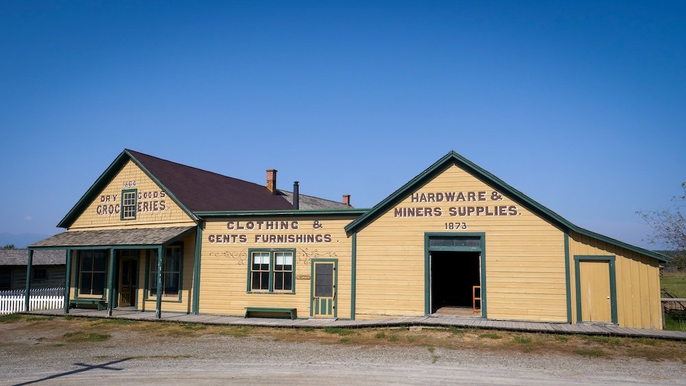 Fort Steele Heritage Town near Cranbrook, BC shows restored historic wooden buildings from the gold rush era, including old storefronts and supply shops, offering visitors an immersive glimpse into pioneer life on an easy day trip from Cranbrook.
