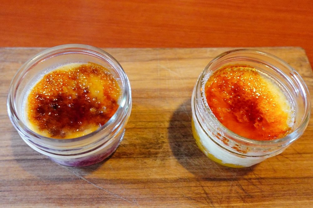 Cranbrook, British Columbia crème brûlée dessert at Numa Lounge & Dining at St. Eugene Resort, featuring two perfectly caramelized custards with crackly sugar tops, served as a refined and indulgent finish to a memorable meal.