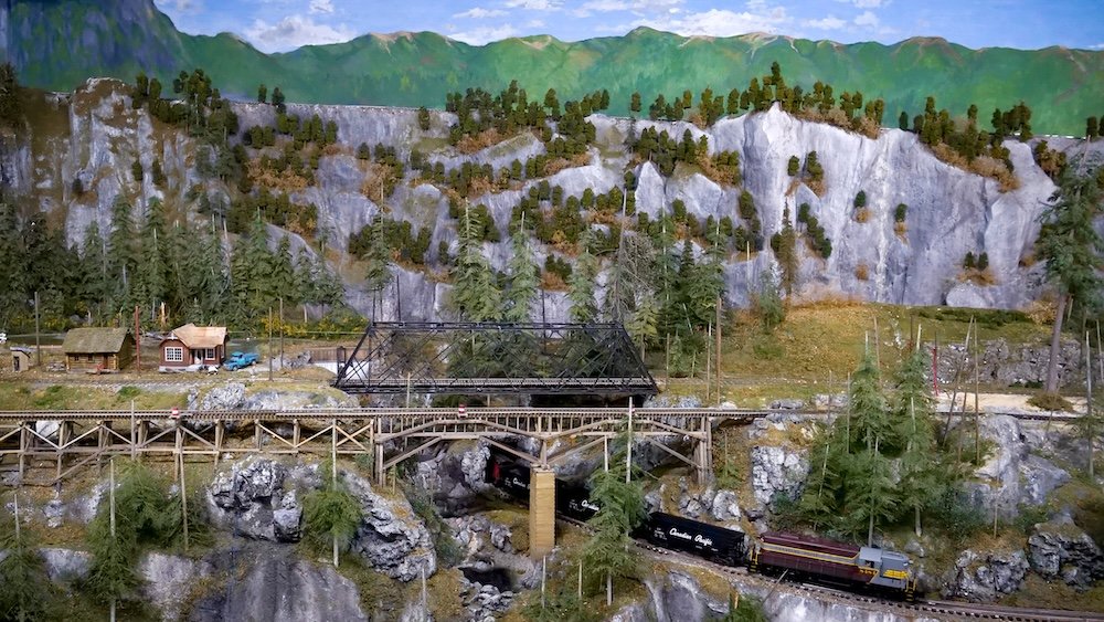 Cranbrook History Centre, British Columbia: detailed model railway display featuring miniature trains crossing bridges through mountain scenery, showcasing the region’s railway history and craftsmanship inside one of Cranbrook’s most popular museums.