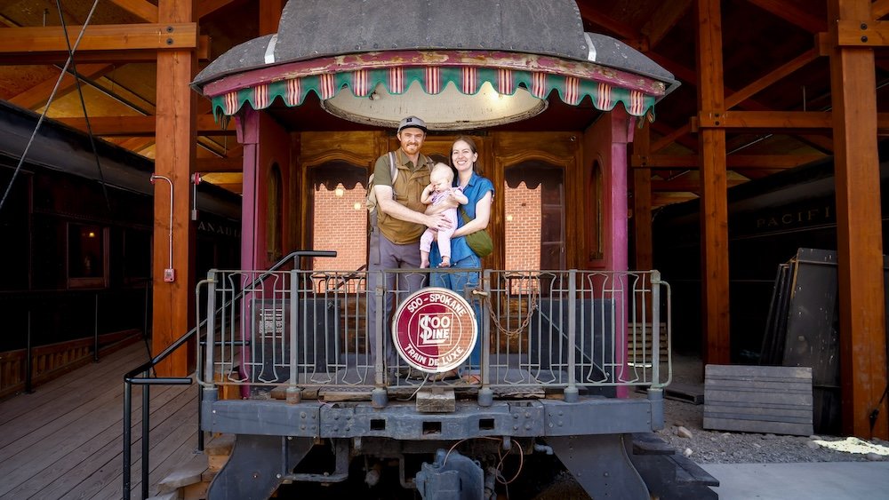 Family visit to Cranbrook History Centre Nomadic Samuel Jeffery, Audrey Bergner, and baby Aurelia posing on a historic railcar platform at the Cranbrook History Centre in British Columbia, capturing a family-friendly stop while exploring Cranbrook’s railway heritage.