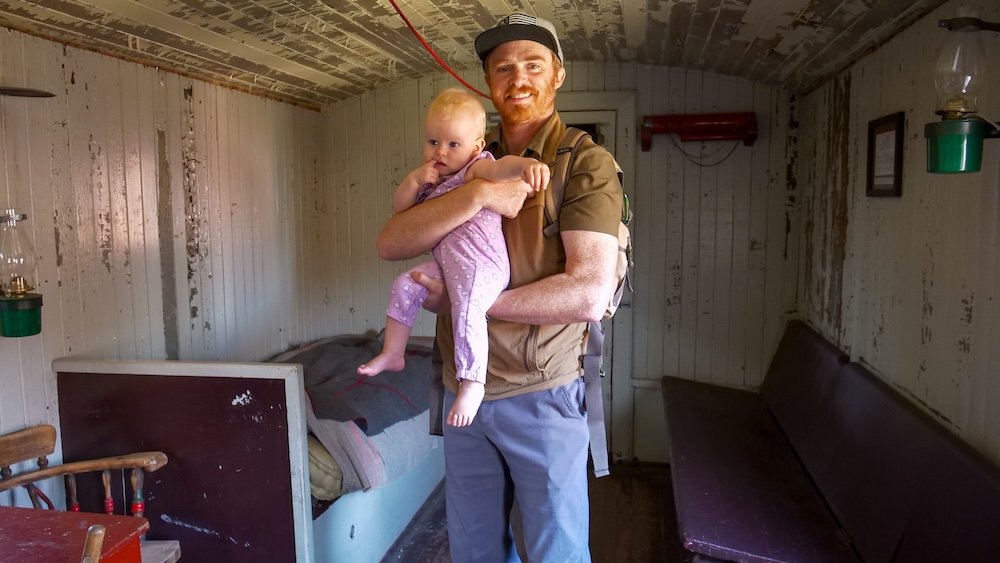 Cranbrook History Centre toddler train tour inside a historic railcar, featuring Nomadic Samuel holding baby Aurelia while exploring preserved railway interiors, highlighting a relaxed, family-friendly museum experience in Cranbrook, British Columbia.