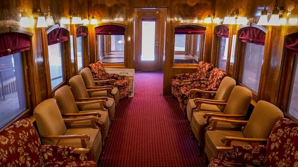 Cranbrook History Centre in summer, British Columbia, featuring the interior of a restored historic train carriage used on the toddler train tour, with vintage seating, warm wood panels, and period details that bring the city’s railway past to life for families.