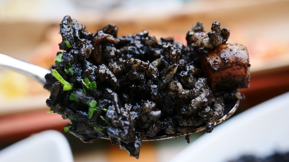 Croatian black squid ink risotto is a tasty seafood meal in Split, Croatia