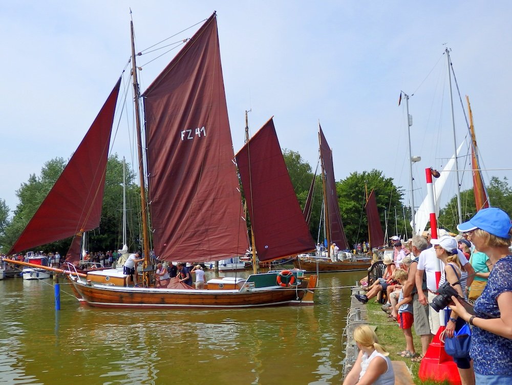 Crowds and sailboats at regatta in Wustrow, Germany 