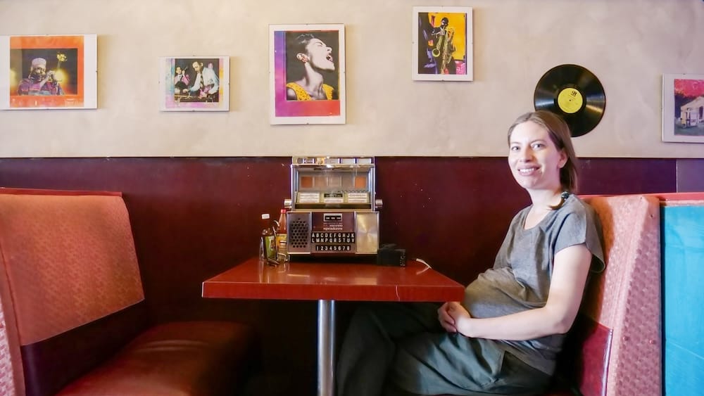 Audrey Bergner Inside DaDeO Restaurant on Whyte Avenue in Edmonton, Alberta, Canada Audrey Bergner sits in a retro booth inside DaDeO on Whyte Avenue in Edmonton, Alberta, Canada, beside a tabletop jukebox, framed jazz artwork and a vinyl record mounted on the wall.