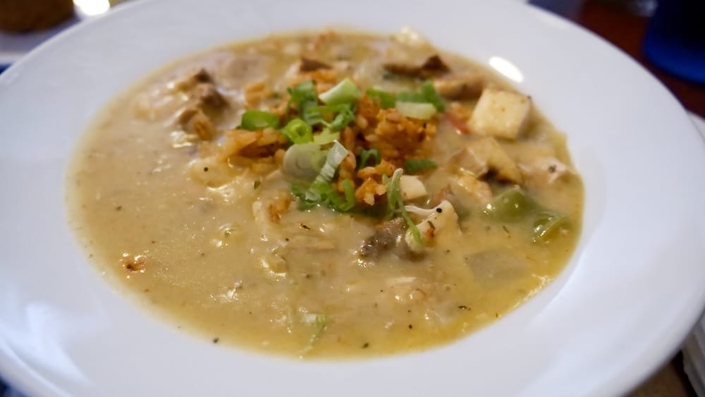 Gumbo at DaDeO on Whyte Avenue in Edmonton, Alberta, Canada Close-up of gumbo at DaDeO on Whyte Avenue in Edmonton, Alberta, Canada, served in a white bowl with rice, green onions and chunks of meat in a thick Creole-style broth.