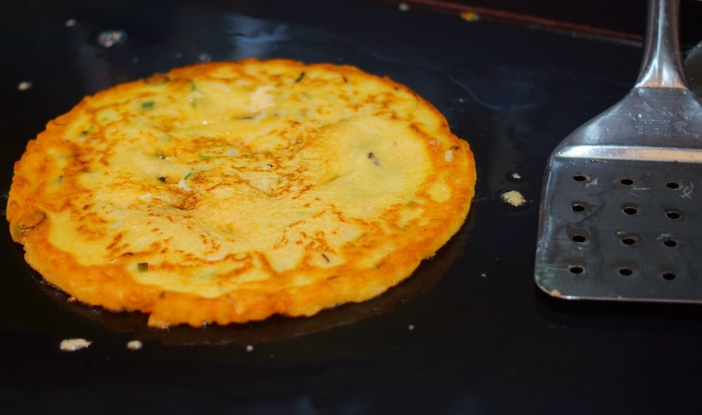 Daejeon Korean pancake on the grill as a popular street food to eat 