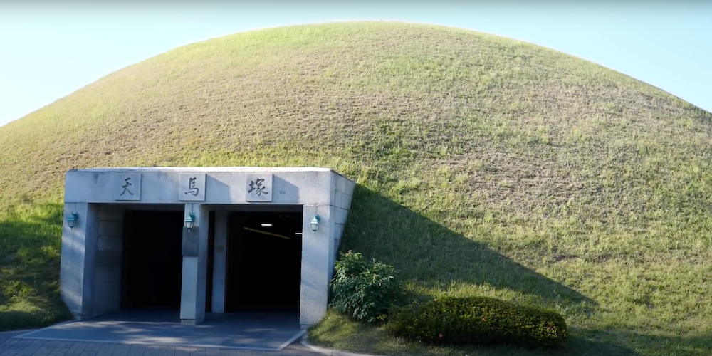 Daereungwon Tomb Complex Cheonmachong grassy burial mounds that look like small, rounded hills with Cheonmachong Heavenly Horse Tomb to enter in Gyeongju, Korea