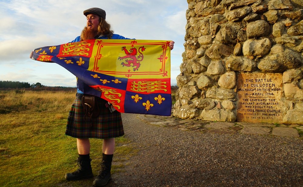 Dave sharing one of the many historical flags from his impressive collection during our Scotland highlands tour