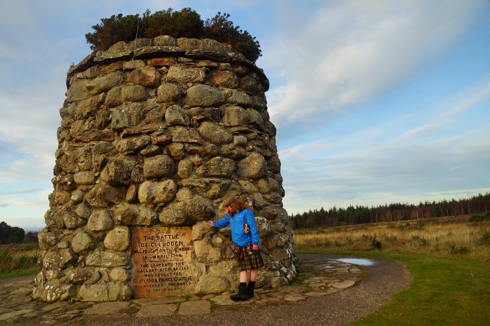 Dave standing beside the 6.1 meter Cairn Memorial during our tour in Scotland