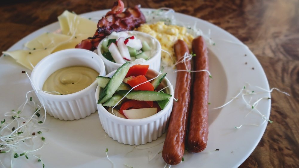 Delicious Polish breakfast including sausage, bacon, eggs, vegetables and more in Krakow, Poland 