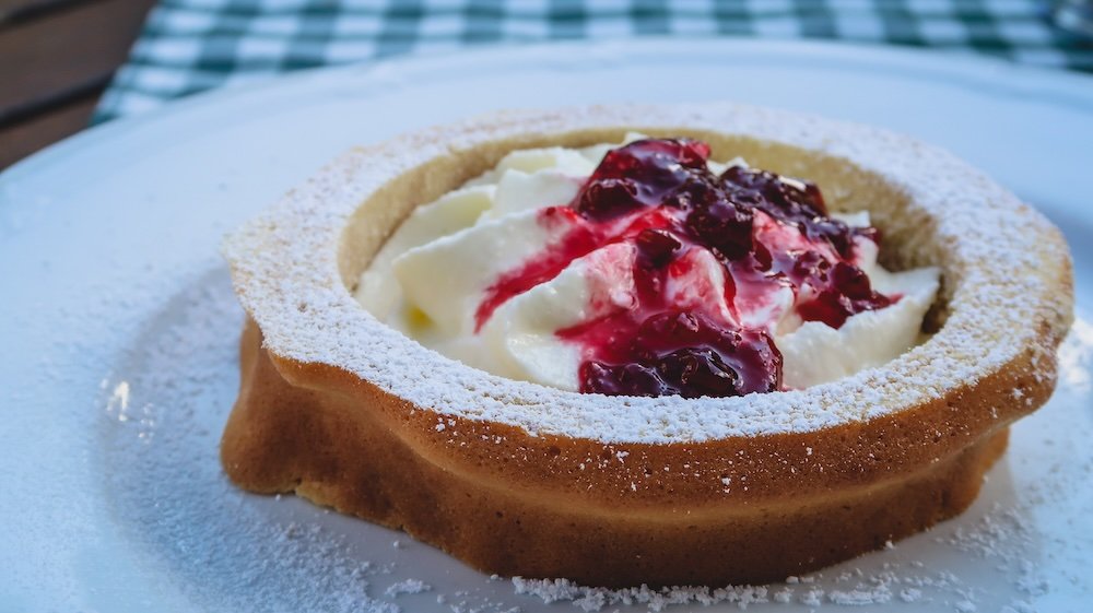 Delicious Tyrolean dessert with berries and cream in Tyrol, Austria 