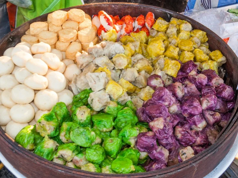 https://nomadicsamuel.com/wp-content/uploads/dim-sum-colorful-giant-serving-tray.jpg.webp?ezimgfmt=rs:379x284/rscb1/ngcb1/notWebP