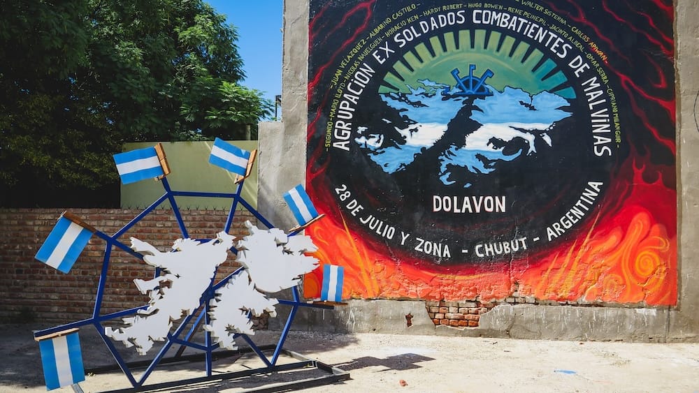 Dolavon Malvinas Mural on a Quiet Monday in Chubut Patagonia Shoulder Season Travel Planning Malvinas veterans mural and map installation in Dolavon, Chubut, on a quiet Monday when the town felt closed, showing the shoulder-season trade-off of fewer crowds but fewer open services.