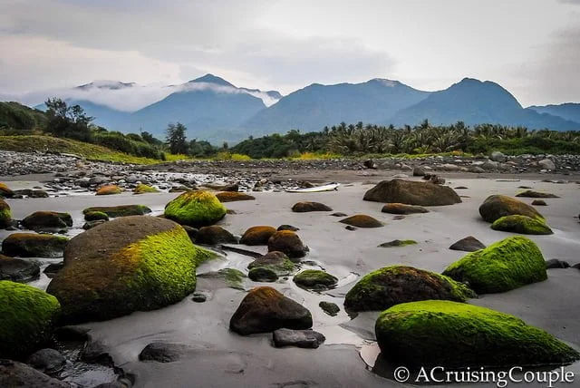 Doulan Taiwan scenery with misty mountains and mirror like water over moss covered rocks