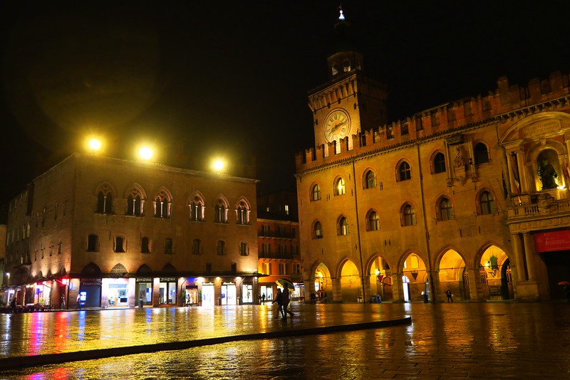 Downtown Bologna, Italy at night with the lights shining brightly