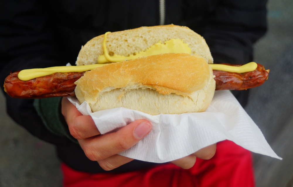 Eating a German Sausage Wurst is popular street food in Berlin, Germany