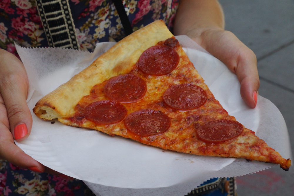 Eating a slice of New York style pizza in Brooklyn