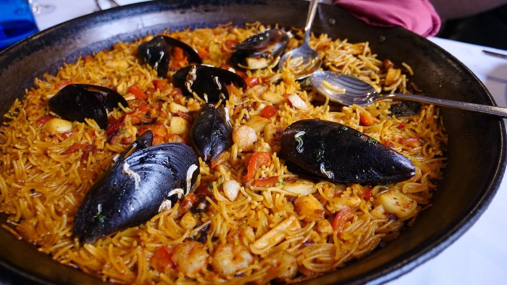 Eating paella Valencia seafood feast in Spain 