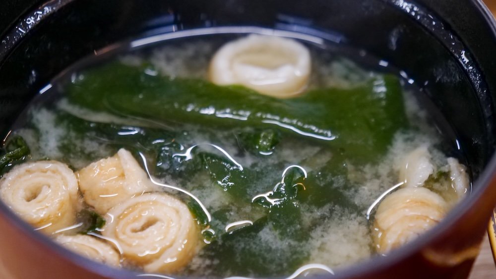 Eating warm miso soup on a day trip to Kiyotsu Gorge, Japan