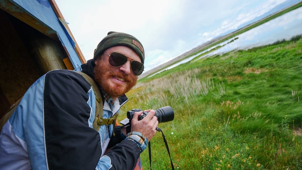 Samuel Jeffery photographing wildlife at Laguna Nunez El Calafate Patagonia Argentina wetlands birdwatching El Calafate Patagonia Argentina Samuel Jeffery photographing wildlife at Laguna Nunez wetlands with camera in hand, capturing birdlife in a quiet natural setting and showcasing real travel experience beyond major attractions in southern Patagonia