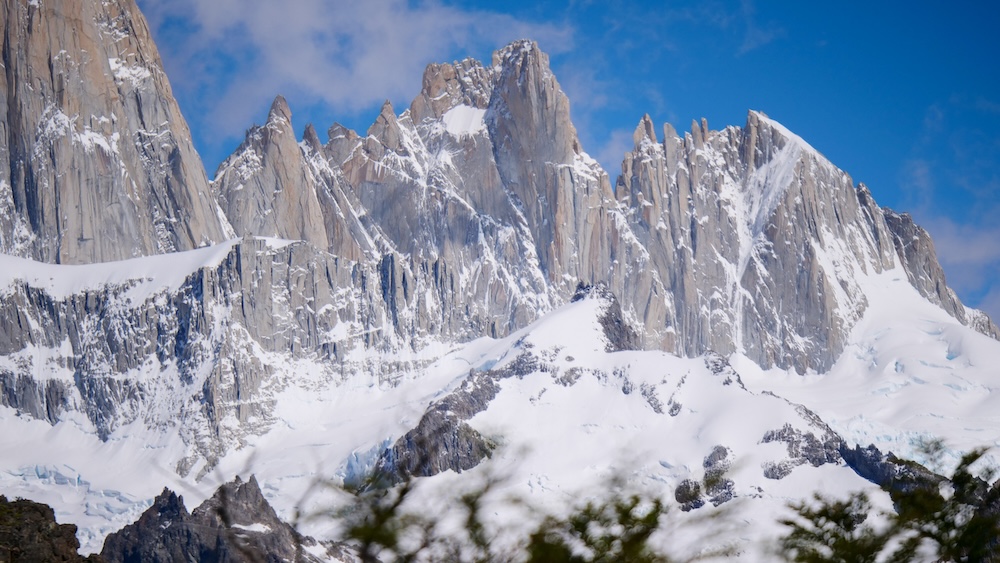 El Chaltén’s legendary Fitz Roy peaks rising sharply above glaciers and snowfields, showcasing the dramatic mountain scenery hikers experience on Patagonia’s most iconic trails and reward viewpoints.