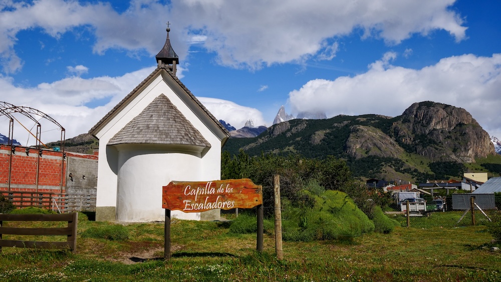 El Chaltén, Patagonia town scene featuring Capilla de los Escaladores with mountain peaks rising behind it, showing how an easy walk through town on foot still delivers iconic scenery and cultural landmarks without committing to longer hiking trails.