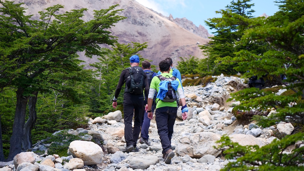 El Chaltén, Patagonia, Argentina rocky hiking trail with a group of travelers carrying backpacks and trekking gear, illustrating preparation for long and physically demanding mountain hikes