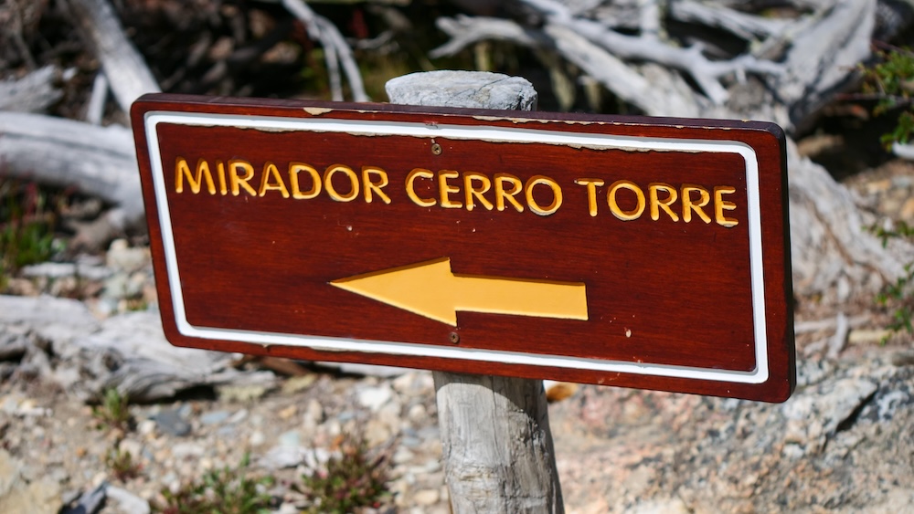 El Chaltén, Patagonia, Argentina trailhead sign pointing toward Mirador Cerro Torre, marking the start of the Laguna Torre hike and helping hikers navigate moderate to long-distance trail routes in the national park