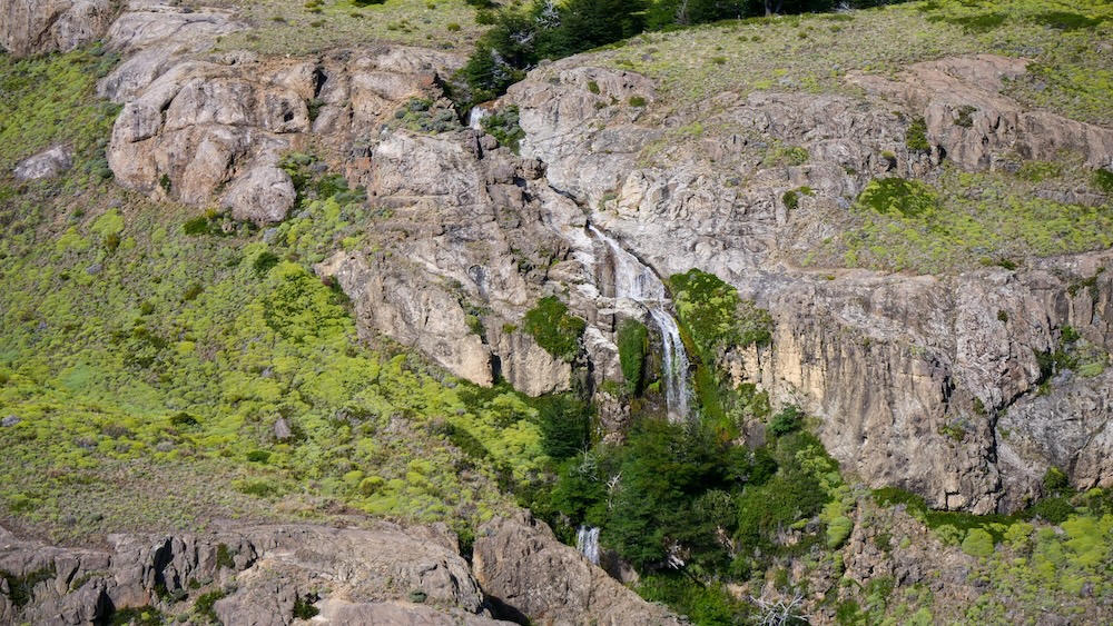 El Chaltén, Patagonia view of a slender waterfall cascading down rocky cliffs at Mirador Margarita, showing a quieter, low-commitment viewpoint hike that delivers a different landscape and scenic payoff without the effort of longer trails.
