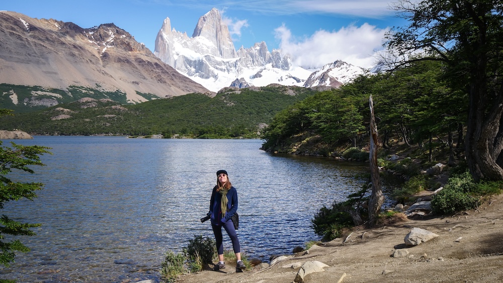 El Chaltén, Patagonia — Audrey Bergner standing at the Laguna Capri viewpoint with Mount Fitz Roy towering behind, soaking in one of Argentina’s most iconic and breathtaking hiking moments.