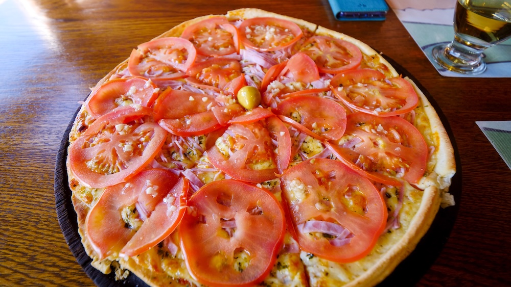 El Chaltén Patagonia pizza served at Patigonicus restaurant, a high-calorie meal enjoyed by hikers after trekking in Los Glaciares National Park near the Fitz Roy and Laguna Torre trails in the trekking capital of Argentina.