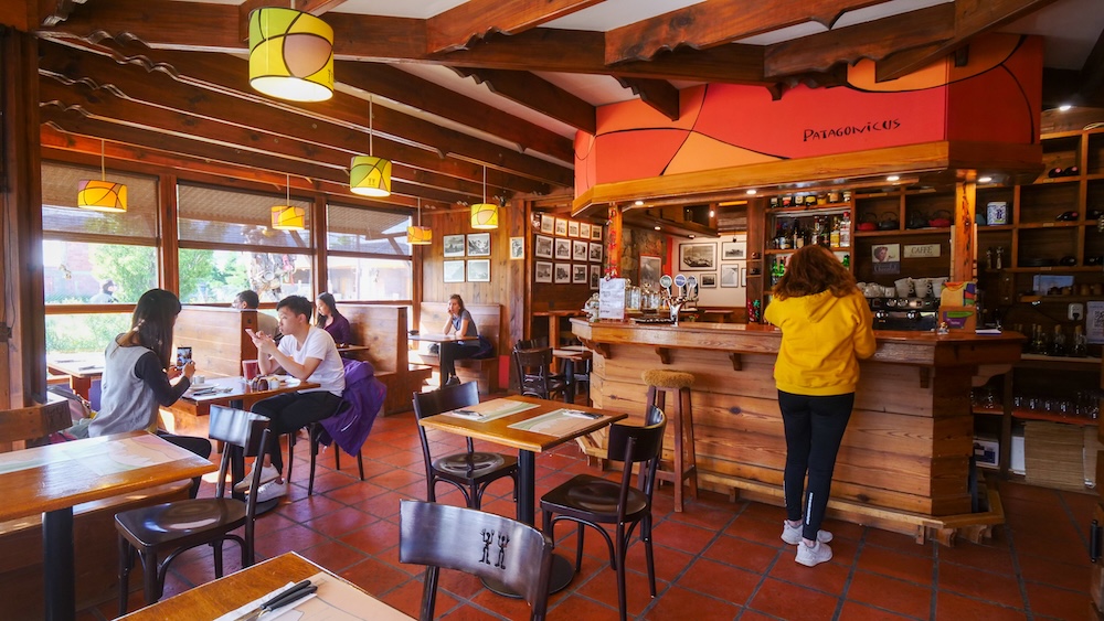 El Chaltén Patagonia Audrey Bergner and hungry hikers waiting for pizza inside Patigonicus restaurant after a long trekking day in Los Glaciares National Park, a popular stop for hikers returning from Fitz Roy and Laguna Torre trails.
