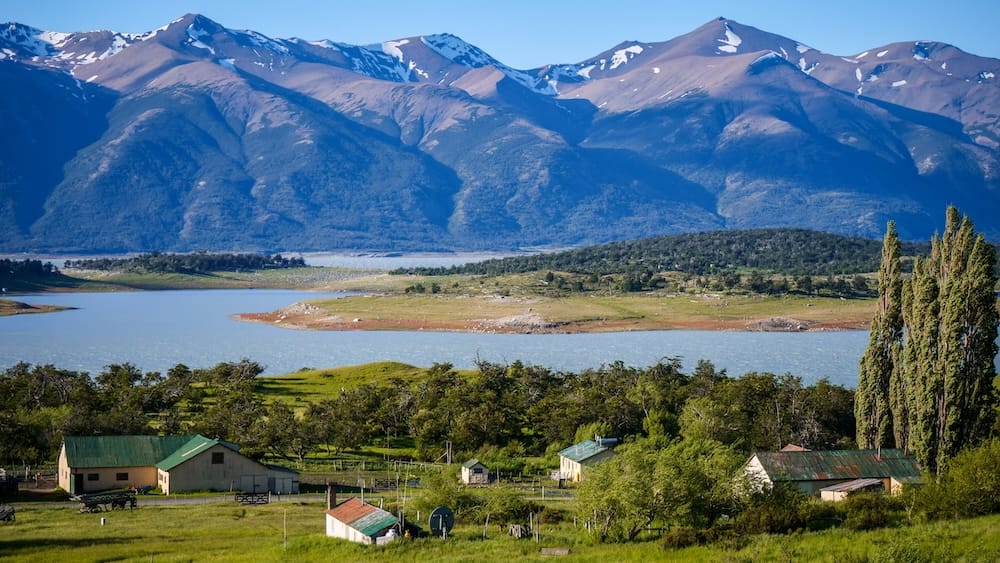 Estancia Nibepo Aike Patagonia ranch landscape Lake Argentino Andes Estancia Nibepo Aike Patagonia ranch buildings near Lake Argentino with snowcapped Andes mountains, showing remote estancia setting where gaucho life unfolds across open land shaped by isolation, weather, and livestock work in southern Argentina.
