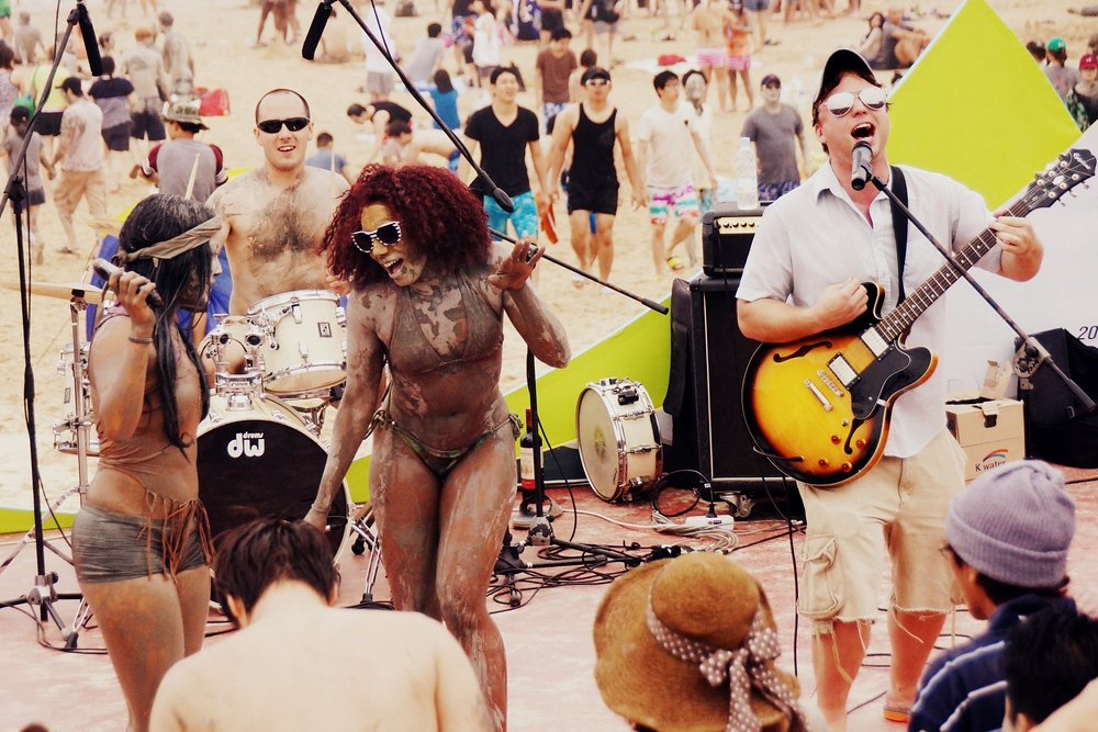 Everybody getting their muddy boogie on during the musical performances at the Boryeong Mud Festival in South Korea