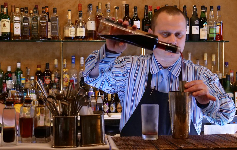 Experiencing the drink scene as a bartender mixes cocktails in Northern Ireland