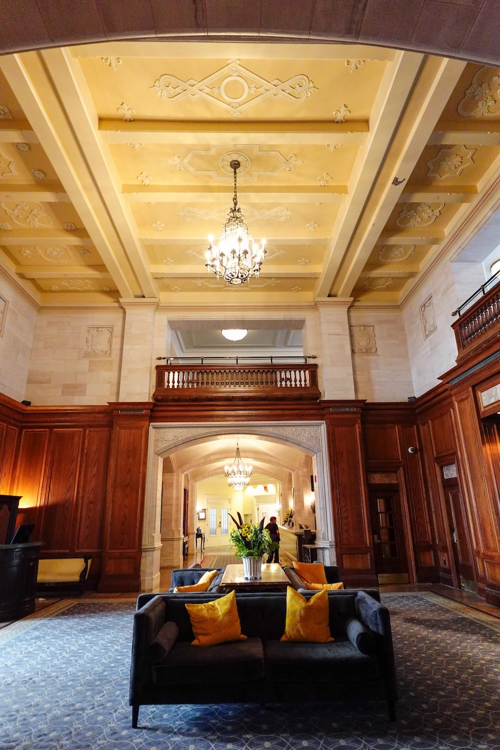 Grand lobby interior at Fairmont Hotel Macdonald The Fairmont Hotel Macdonald’s grand interior features ornate coffered ceilings, crystal chandeliers, carved wood paneling and elegant lounge seating, showcasing the heritage charm and classic architectural details that give this historic Edmonton château hotel its timeless atmosphere.