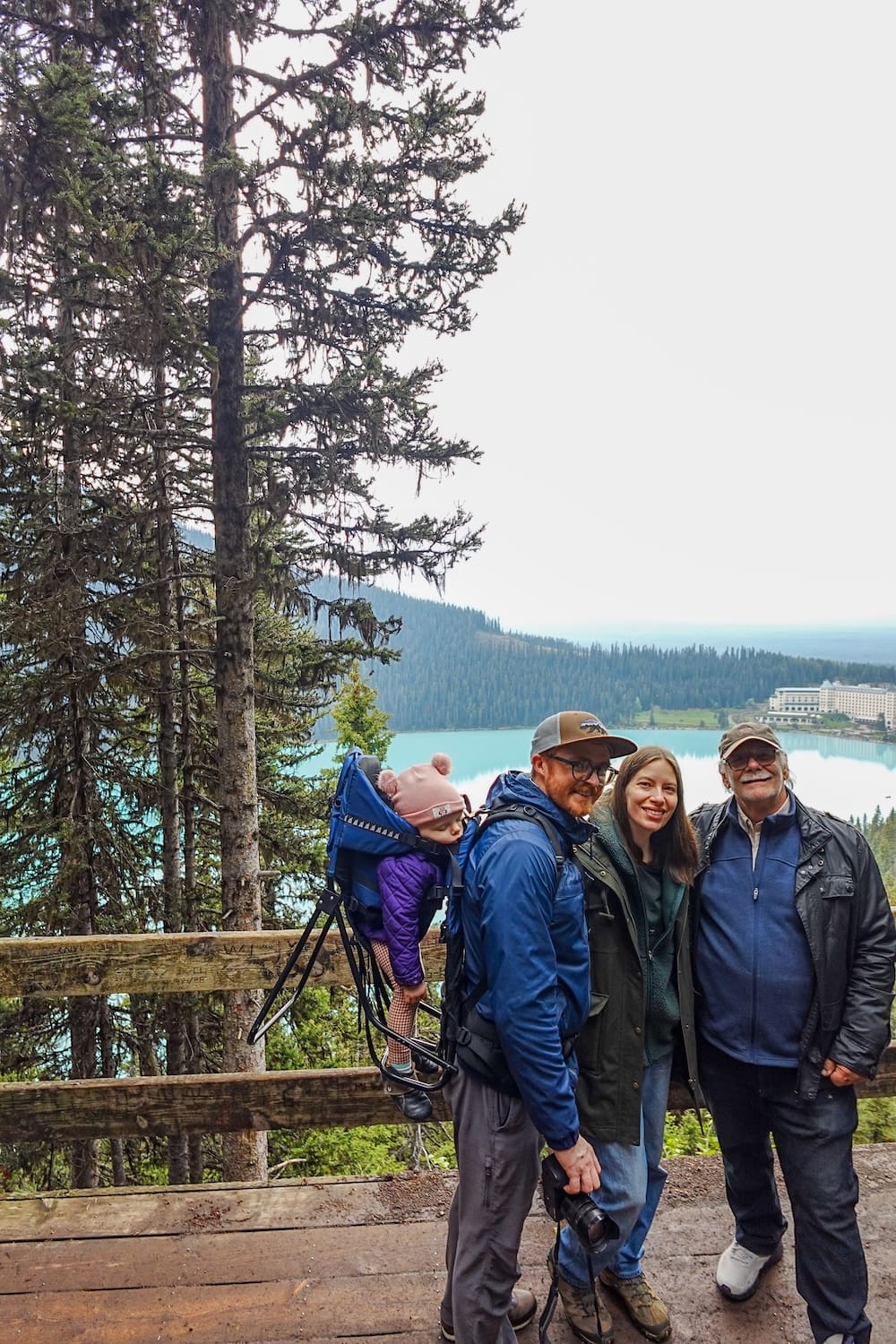 Fairview Lookout above Lake Louise in Banff National Park Alberta Canada with Samuel Jeffery family Samuel Jeffery, Aurelia Jeffery, Audrey Bergner and Daniel Bergner stand at Fairview Lookout above Lake Louise in Banff National Park, Alberta, Canada, with the turquoise lake and Fairmont Chateau Lake Louise visible through the trees behind them.