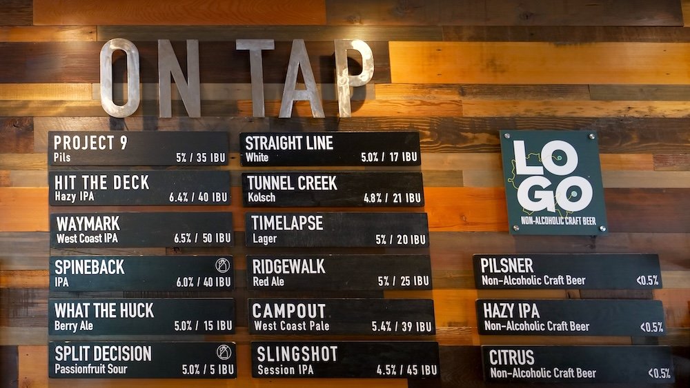 What’s on tap at Fernie Brewing Company What’s on tap board inside Fernie Brewing Company in Fernie, British Columbia, displaying the current beer lineup including lagers, IPAs, red ale, sour, and non-alcoholic options, giving visitors a clear look at the rotating taps available for tasting in the brewery’s welcoming taproom.