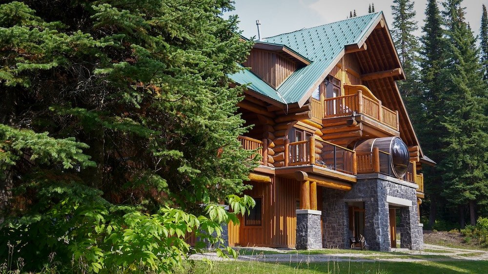 Fernie, British Columbia mountain lodge scene showing Island Lake Lodge surrounded by evergreen forest and alpine scenery, a standout day trip option from Fernie offering scenic hiking trails, peaceful lakeside views, and a memorable escape into the Canadian Rockies.