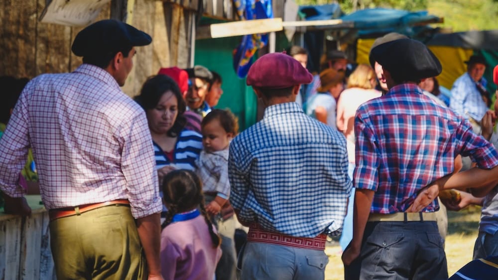 Fiesta Gaucha in El Bolson Patagonia Argentina with traditional local culture Local gauchos and families gathered at Fiesta Gaucha in El Bolson Patagonia Argentina wearing traditional clothing and berets, showcasing regional culture and community life