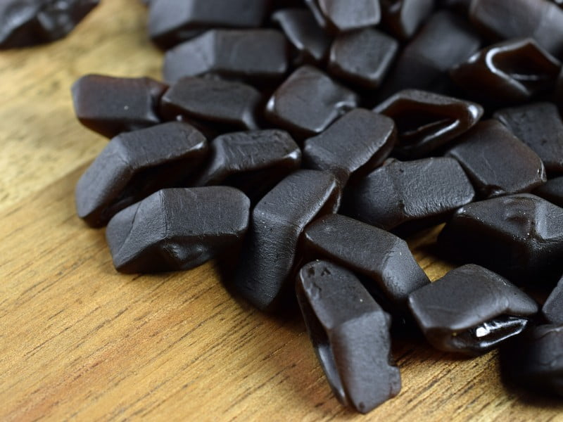 Finnish Salmiakki candy spread out on the table is a popular salty liquorice snack for locals that is worth trying once as a foreigner 