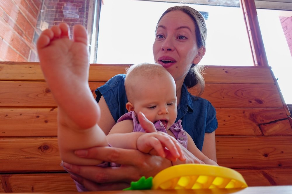 Family-friendly lunch at Fire Hall Kitchen & Tap in Cranbrook, BC with baby Aurelia Fire Hall Kitchen & Tap in Cranbrook, BC during a relaxed family lunch, with baby Aurelia happily playing at the table while enjoying the space, showing how this popular restaurant offers a welcoming, baby-friendly environment for parents traveling with infants or toddlers.