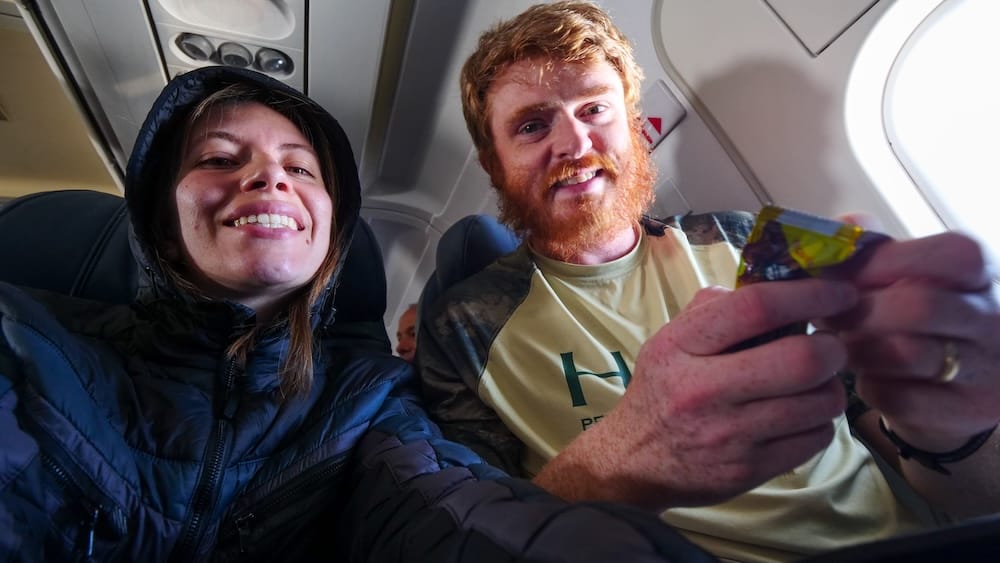 Samuel Jeffery and Audrey Bergner on a flight to Ushuaia, Tierra del Fuego, Argentine Patagonia Samuel Jeffery and Audrey Bergner smile aboard a flight to Ushuaia, Tierra del Fuego, Argentine Patagonia, seated by the cabin window with a snack in hand during the approach.