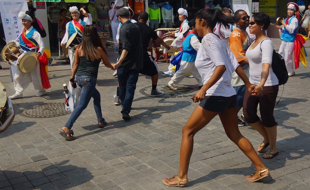 Foreigners participating in a dance with Korean traditional performers nearby American US army base in Pyeongtaek, Korea 